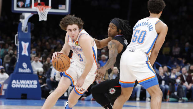 Dec 18, 2021; Oklahoma City, Oklahoma, USA; Oklahoma City Thunder guard Josh Giddey (3) drives to the basket around LA Clippers guard Terance Mann (14) during the first quarter at Paycom Center. Mandatory Credit: Alonzo Adams-USA TODAY Sports